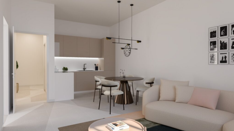 Soggiorno con cucina tortora, tavolo rotondo, divano chiaro e dettagli di design, illuminazione sospesa e parete decorata.