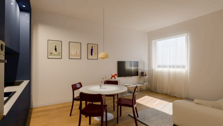 Zona giorno open space con cucina blu opaco, parete decorata e arredi minimali in legno e rosso scuro.