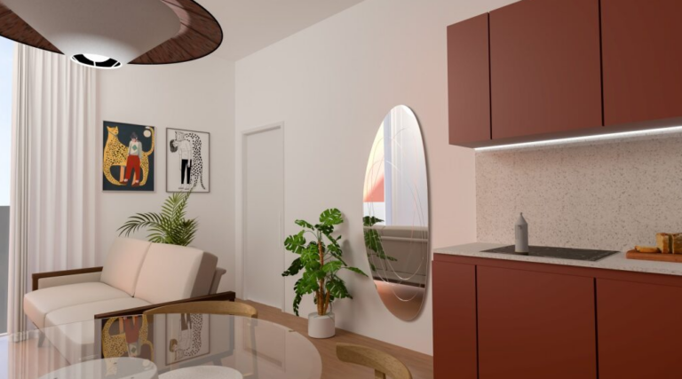 Zona giorno con cucina color terracotta, parete decorata con opere artistiche e piante indoor.