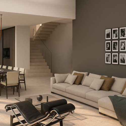 Zona living con divano chiaro, chaise longue moderna e scala in pietra con parapetto in vetro