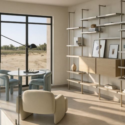 Angolo lettura con poltroncine moderne, tavolo tondo e libreria a giorno in una villa di lusso a Dubai